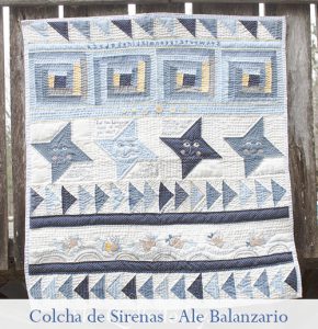 colcha de patchwork con sirenas y bordado